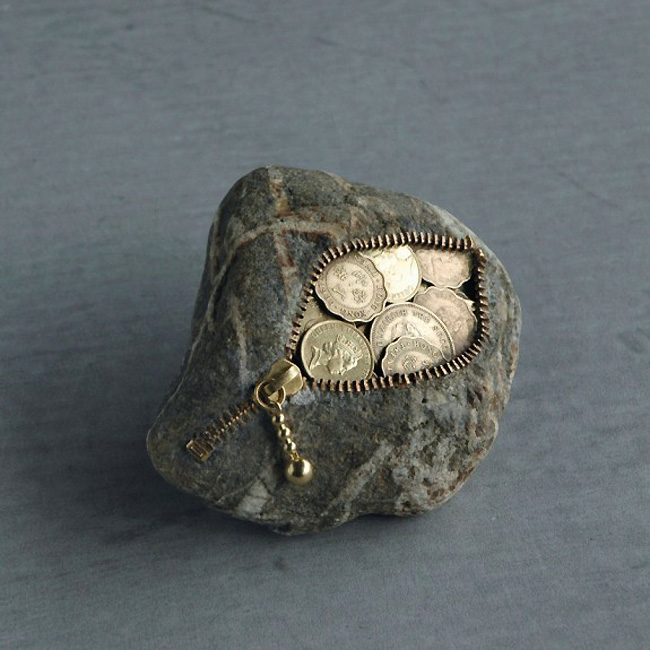 Everyday, familiar items like coins and zippers transform the stones into other, stranger forms.