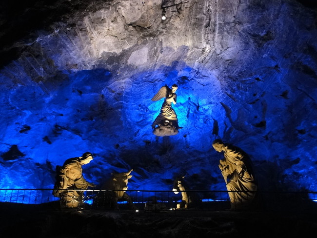 This sculpture shows the Holy Family. The Salt Cathedral combines the smooth forms of traditional sculpture with the striking geometric forms of the natural halite rock that makes up the mountain and the mines.