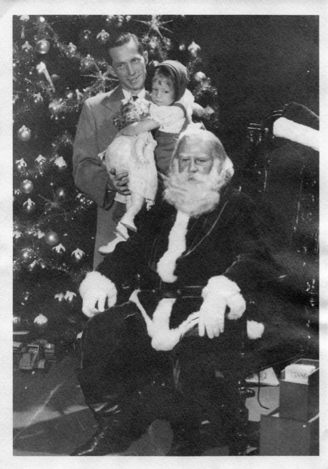 The father in this picture actually looks creepier than Santa Claus.