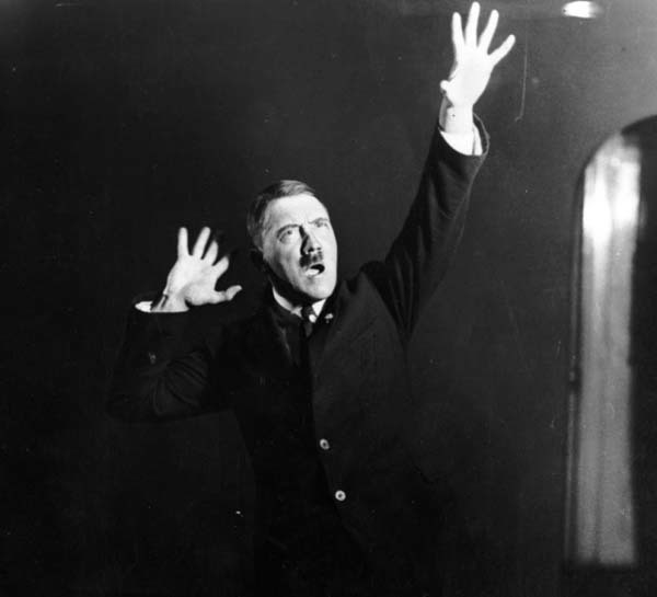 14.) Adolf Hitler rehearsing his speeches in front of a mirror (1925).