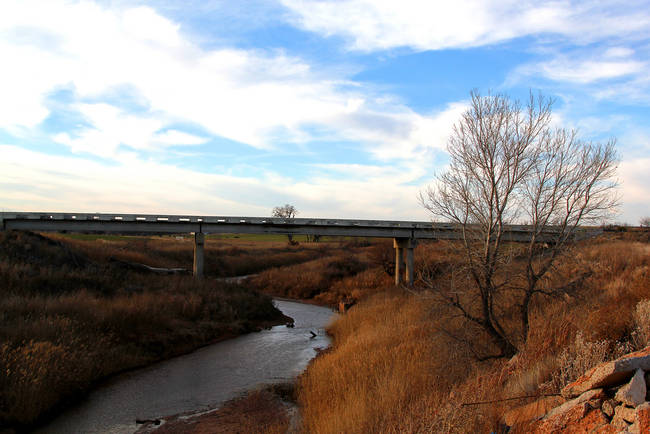 The story behind Dead Woman's Crossing in Weatherford, Oklahoma, follows the death of a young mother named Katy DeWitt James. James was tricked by a shady prostitute named Fannie Norton. Norton befriended James on the train before robbing and murdering her, disposing her body under the bridge and giving her baby to a local boy for his mother to raise.