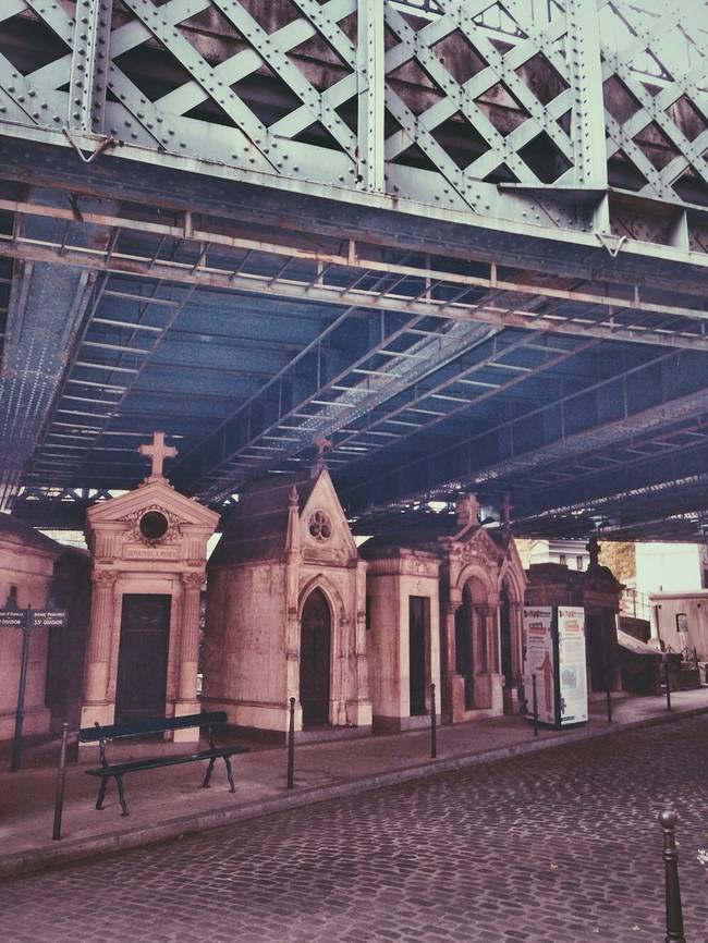 The mausoleums are designed to look like little churches, and next to the industrial blue bridge, they make for a striking cemetery setting.