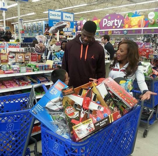 Johnson, who wears #80 on his jersey, gives the kids 80 seconds to run through the store and fill a shopping cart. In reality, the kids get even more than what they can grab in those 80 seconds as Johnson also gives each child a gaming system and games as well as gifts to give to their siblings.