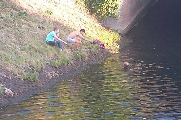 It took them almost ten minutes to climb over the gates and scale the decline down to the waterway. By the time they got there, they were afraid she'd get sucked further downstream.