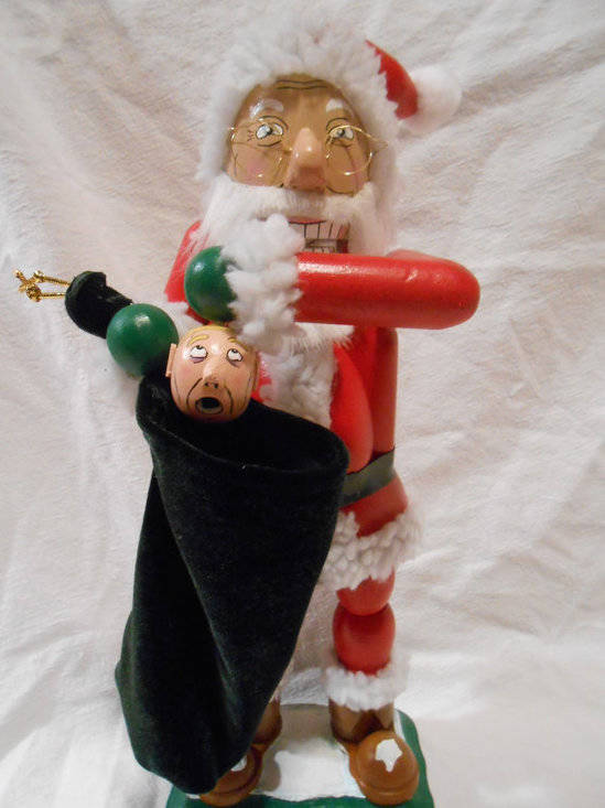 I can't tell if this Santa nutcracker is pulling the elf out of the bag or into it, but I really don't want to know.