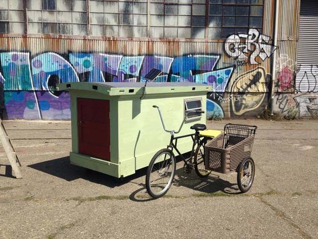 This house is equipped with solar panels. The shopping cart bike provides the homeless with a method of transportation and storage.