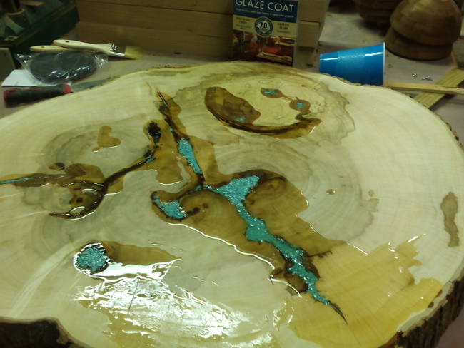 Using epoxy resin and some crushed turquoise inlay, they added a little bit of color to the soon-to-be coffee table.