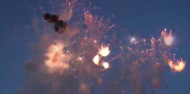 Spectators in a town in Italy were enjoying a nice evening firework display. Looks pretty cool, right?