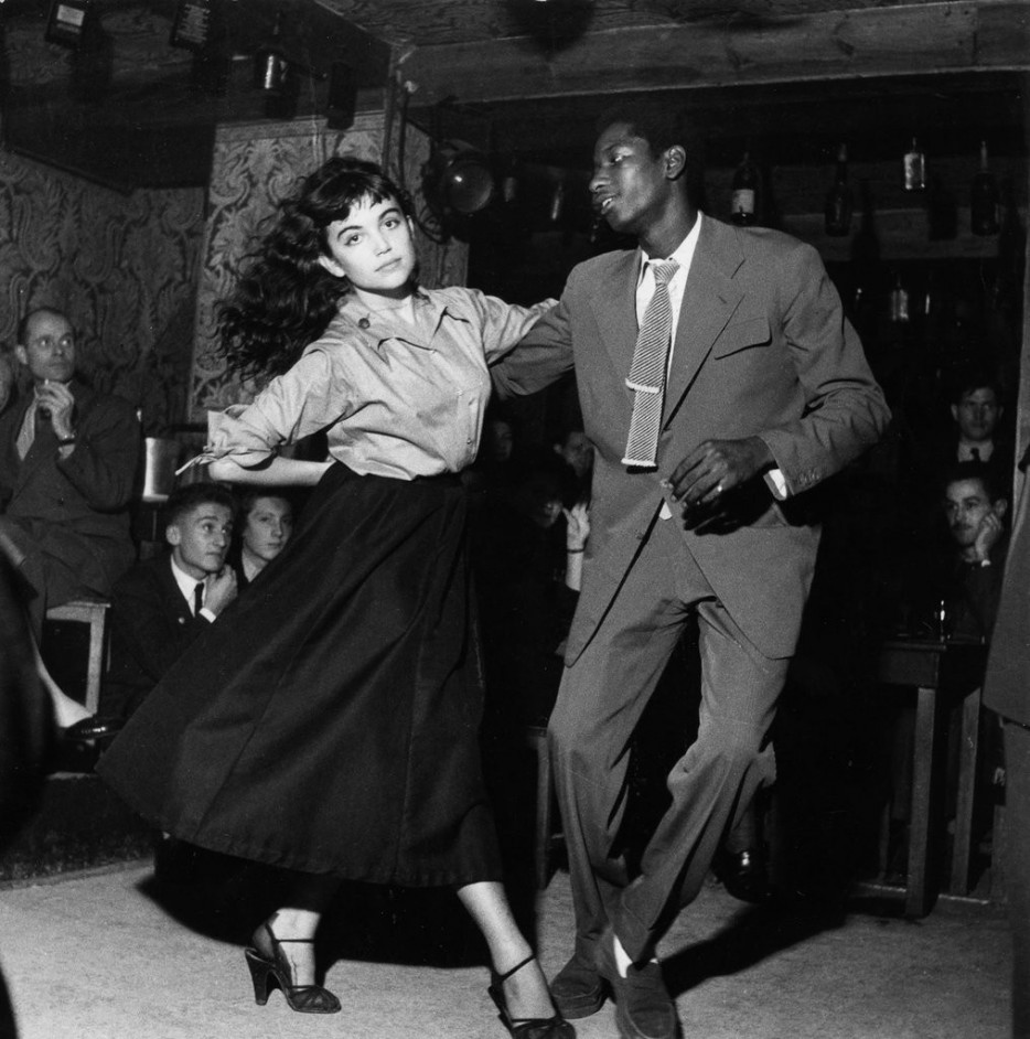 A couple dancing in a 1950's "Be Bop" theater as everyone looks on.