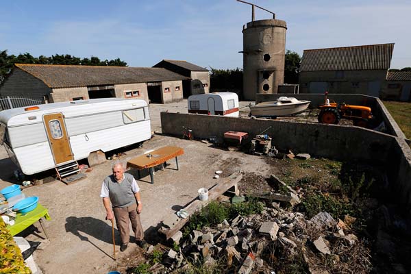 Farmer Raymond Bertot, who was 19 when allied troops came ashore in 1944, poses on the property.