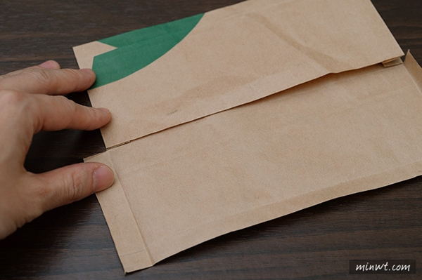 Flatten the bag, then cut the it into five pieces according to the creases that shape it. Then fold the bottom portion over.