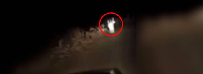 Watch This Mysterious, Ghost-Like Figure Chase A Car Down A Dirt Road