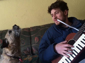 A Talented Dog Sings The Blues While His Owner Plays Along On His Instruments